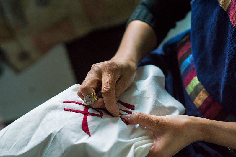 Close Up Photo of Woman sewing by hand