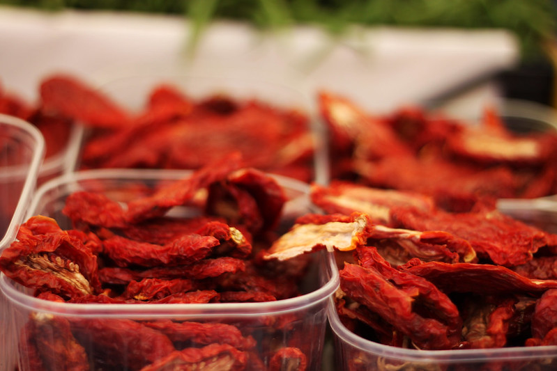 Close Up Photo of dried red peppers in plastic containers
