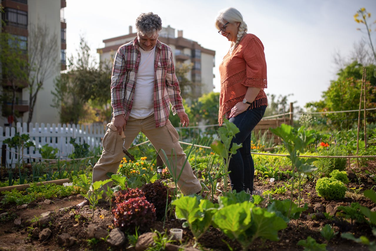 Man and Woman Standing at Their Vegetable Garden