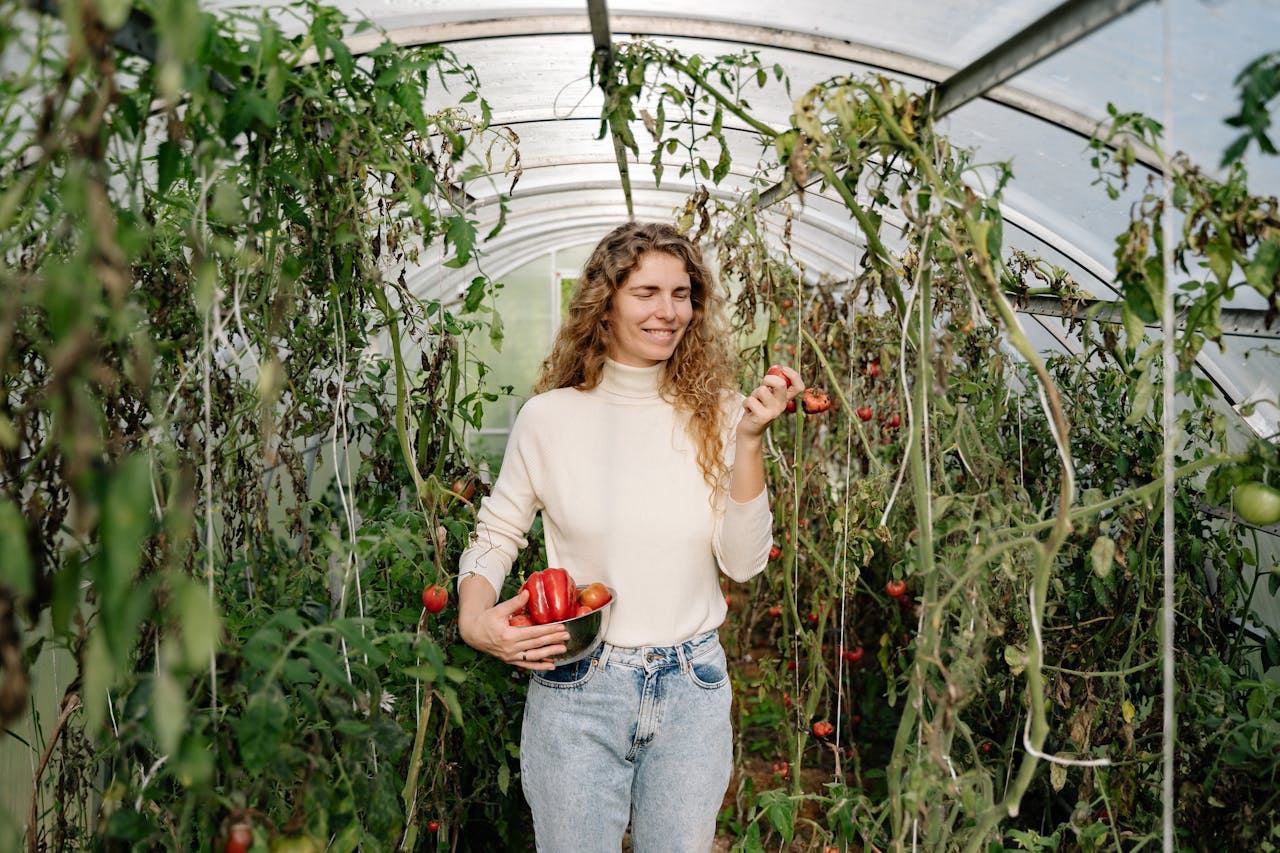 Woman holding a Bowl of Harvested Vegetables