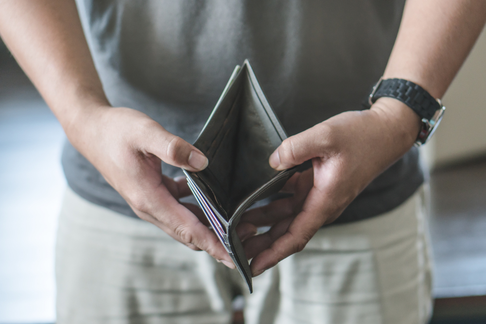 Person open his empty wallet