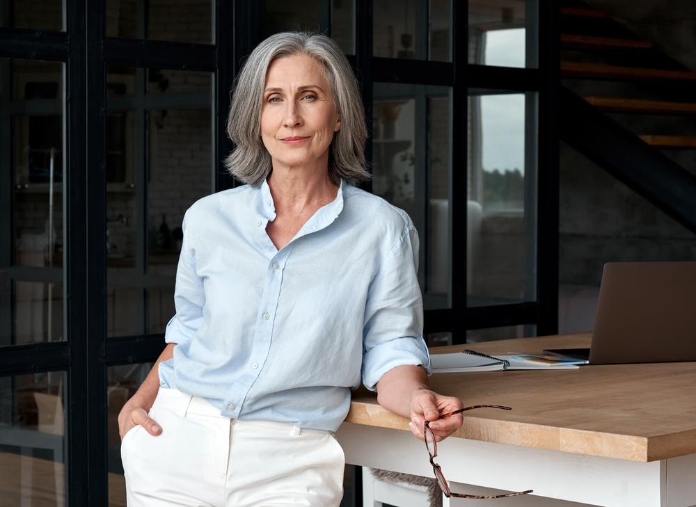 middle aged woman standing at workplace
