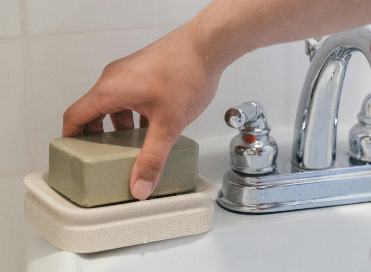 Person Holding a Bar Soap