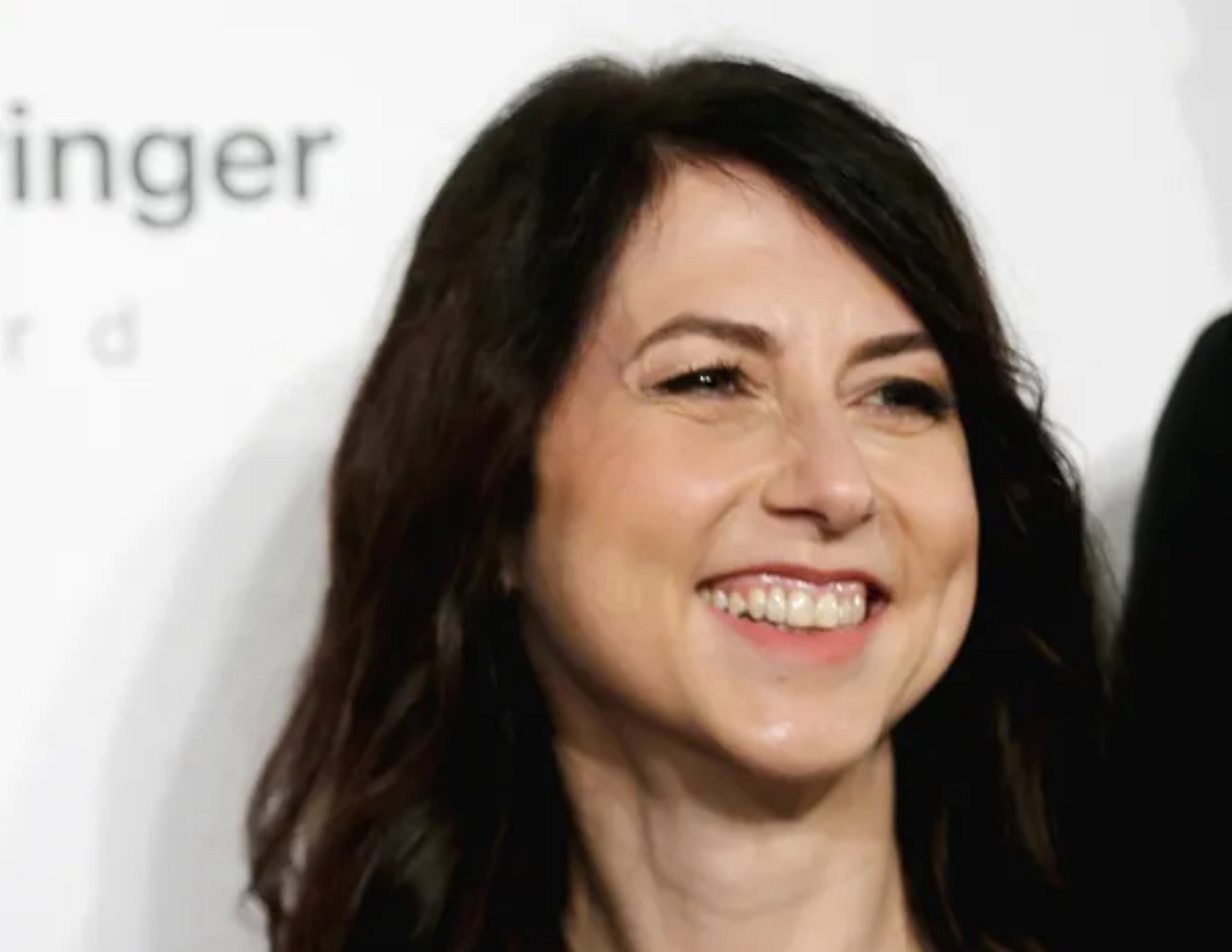 Mackenzie Scott looking at side and smiling.