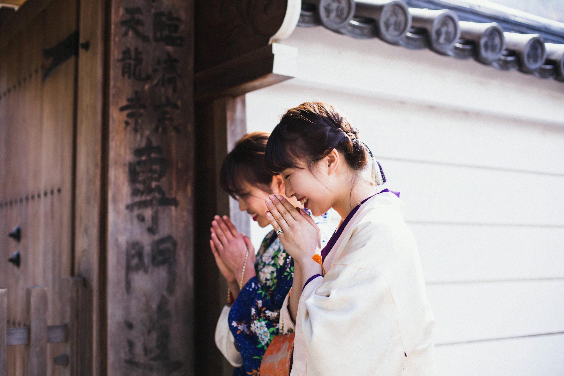Two Women Smiling and Praying