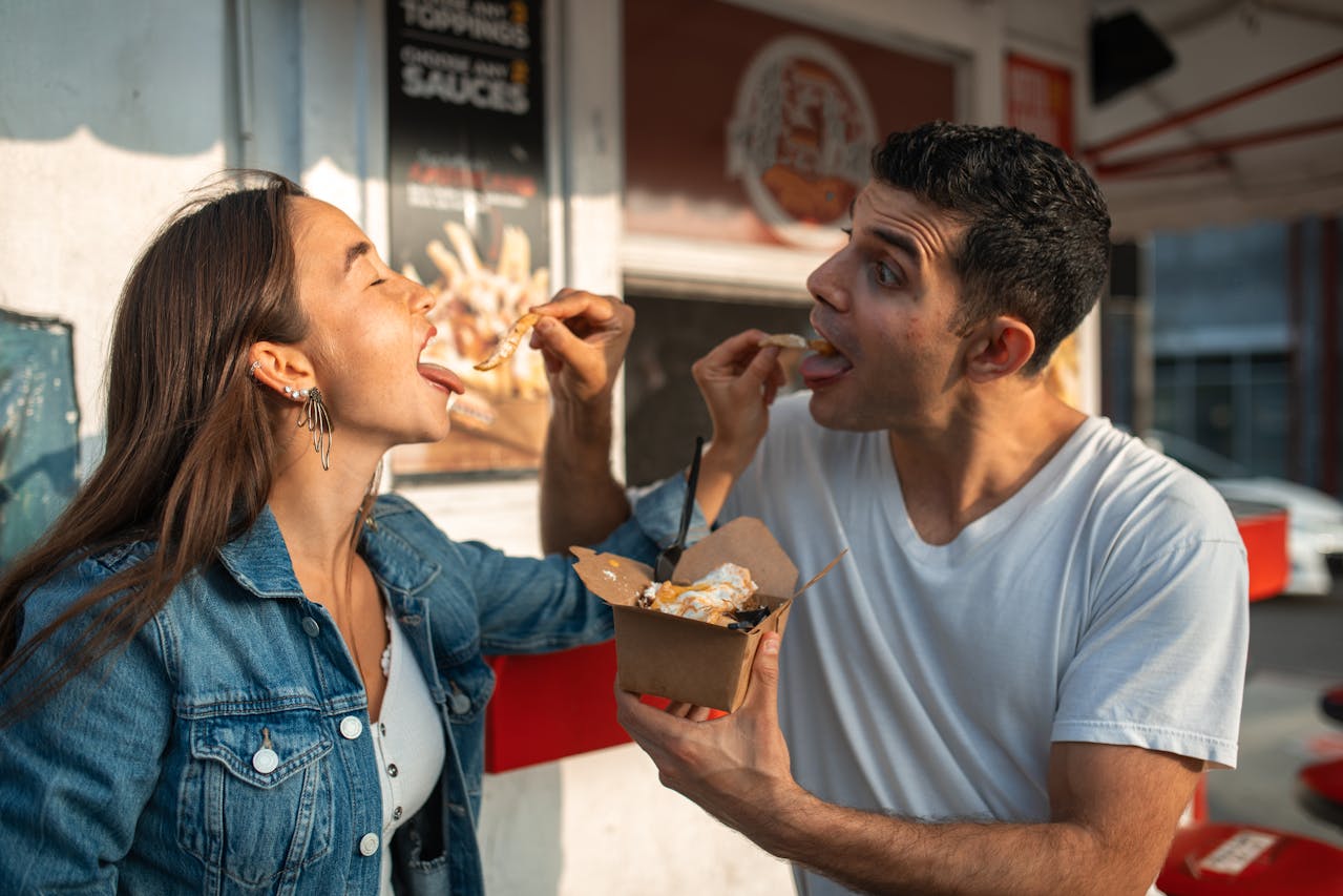 Man and Woman Eating outside of fast food place.