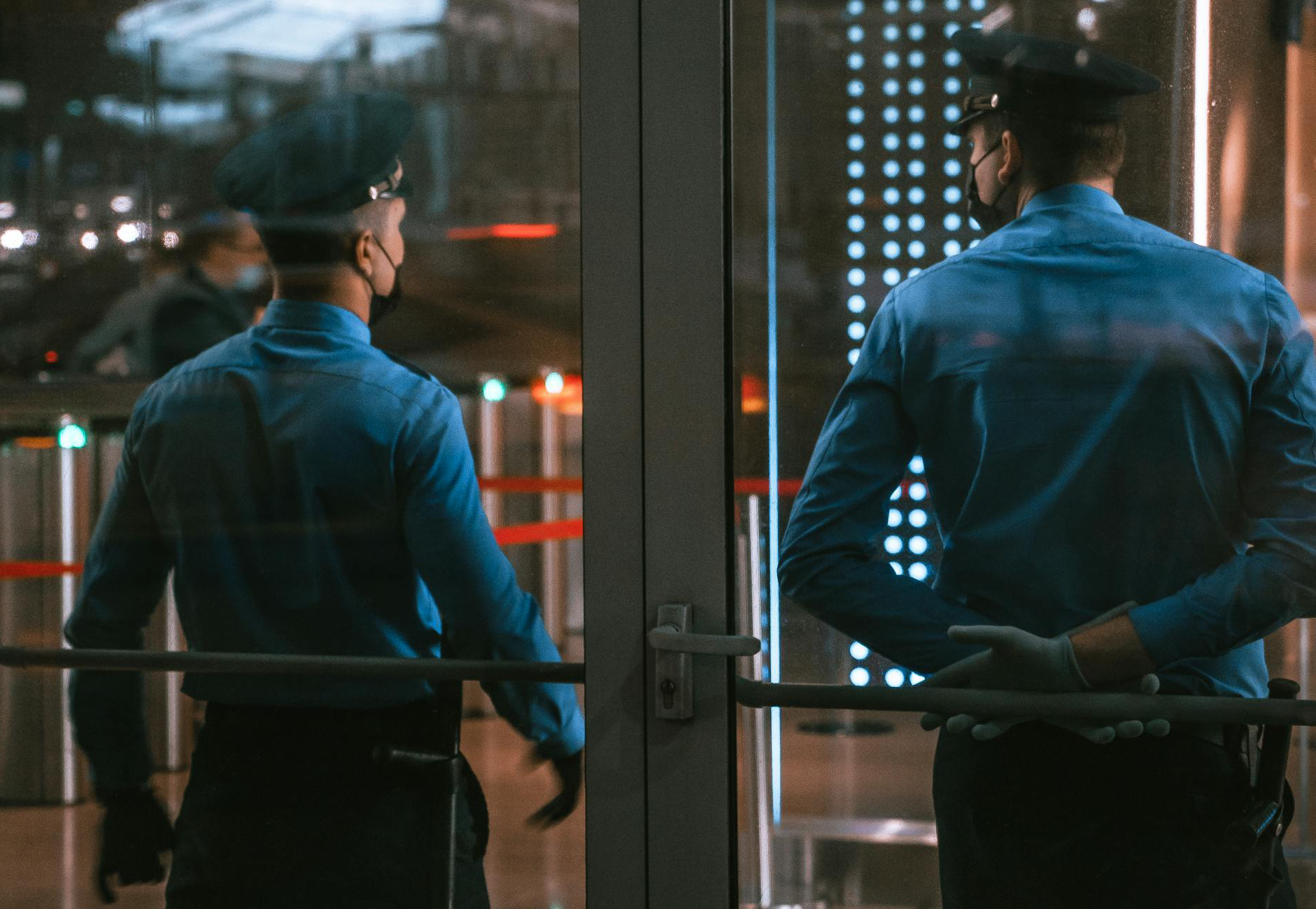 Men in Blue Long Sleeve Uniforms Standing Outside