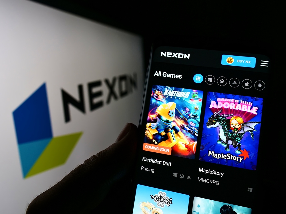Person holding cellphone with webpage of video game company Nexon Co. Ltd.