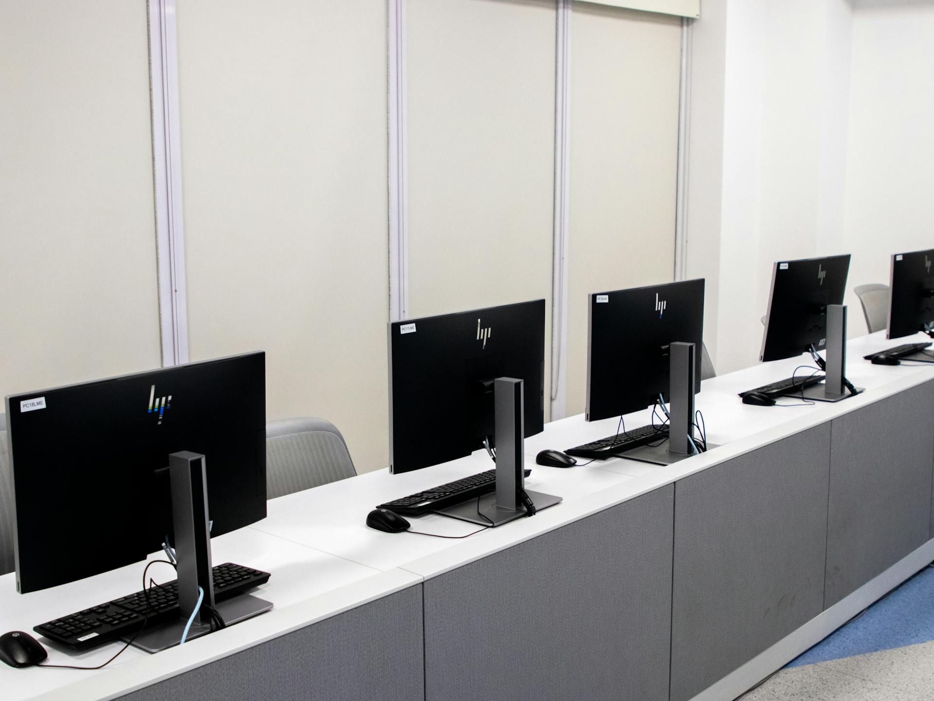 A row of computers with monitors on them