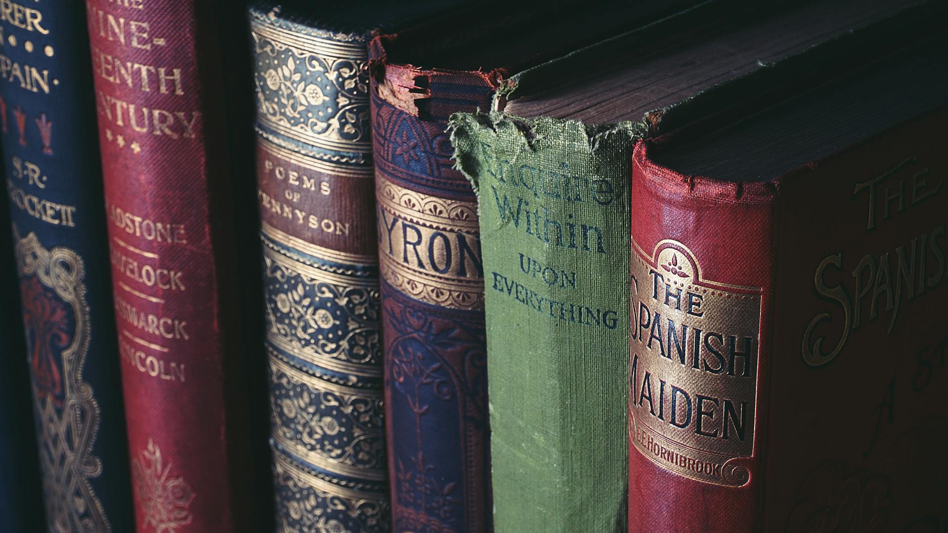 Row of antique books with worn covers