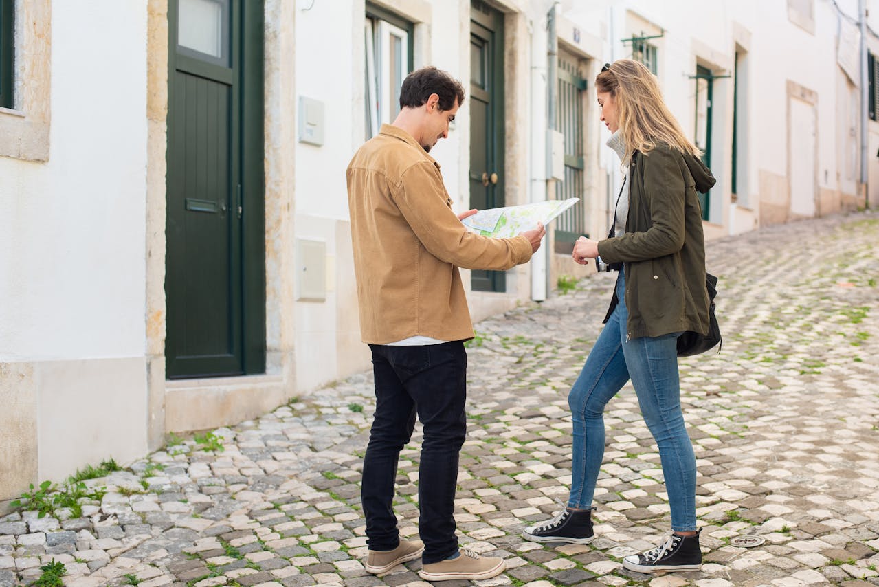 Man and Woman Walking on the Street and looking at map.