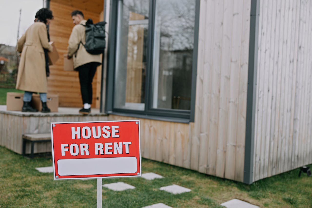 Red and White Sign Outside the House