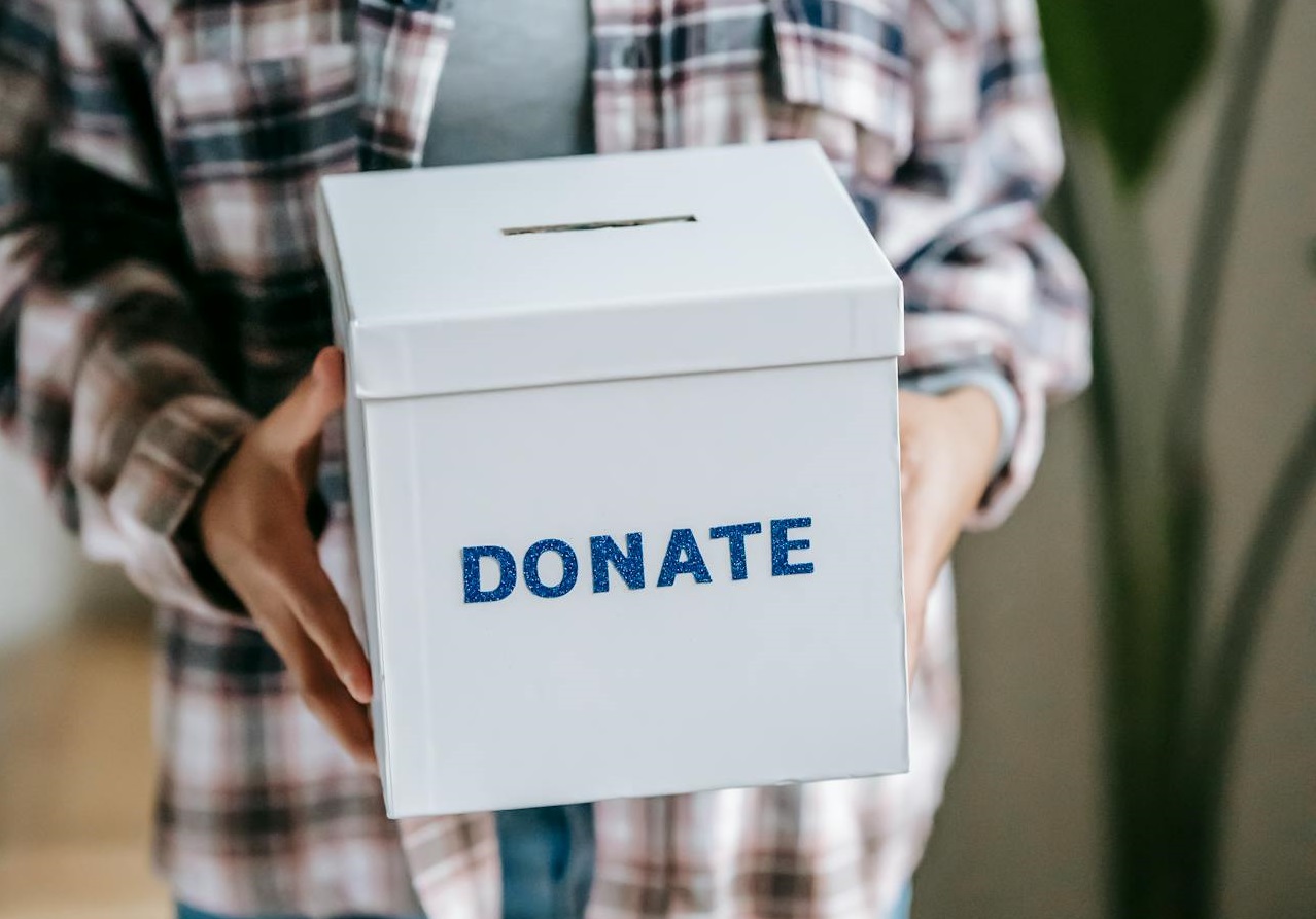 Woman holding box with inscription Donate