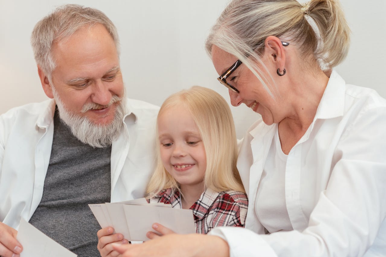 Photo of a Kid and Her Grandparents