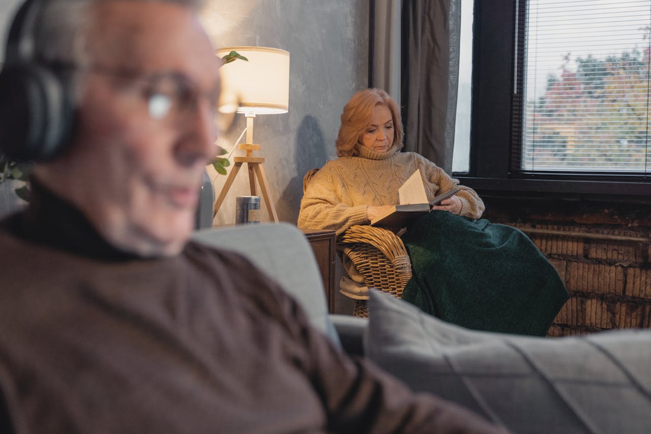Man in Brown Sweater and Woman Reading a Book