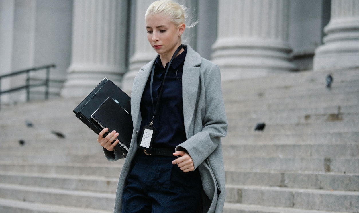 /serious-businesswoman-hurrying-with-documents-from-courthouse