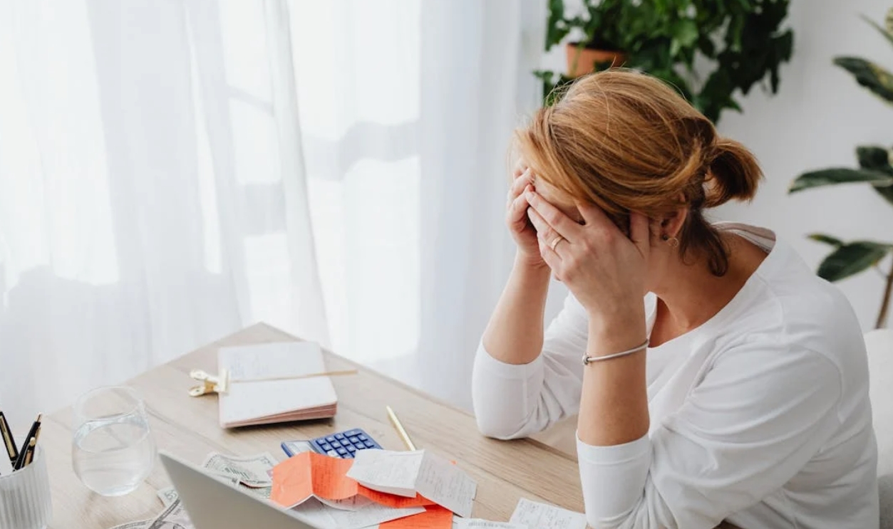 /woman-and-receipts-on-desk