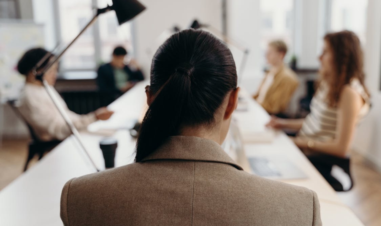 woman-in-brown-coat-sitting-on-chair