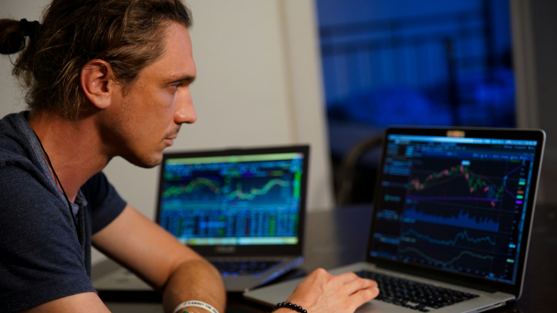 man sitting in front of the MacBook Pro