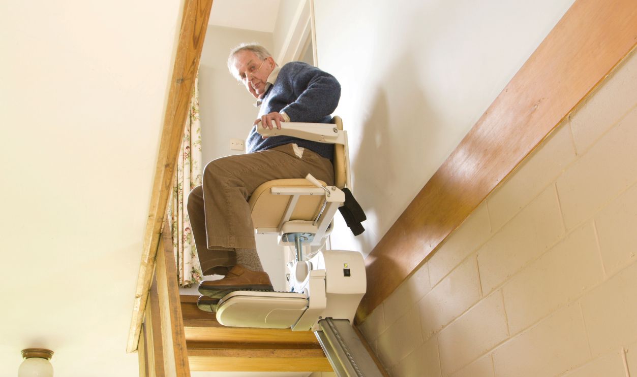 Elderly Man Using A Stair Lift 