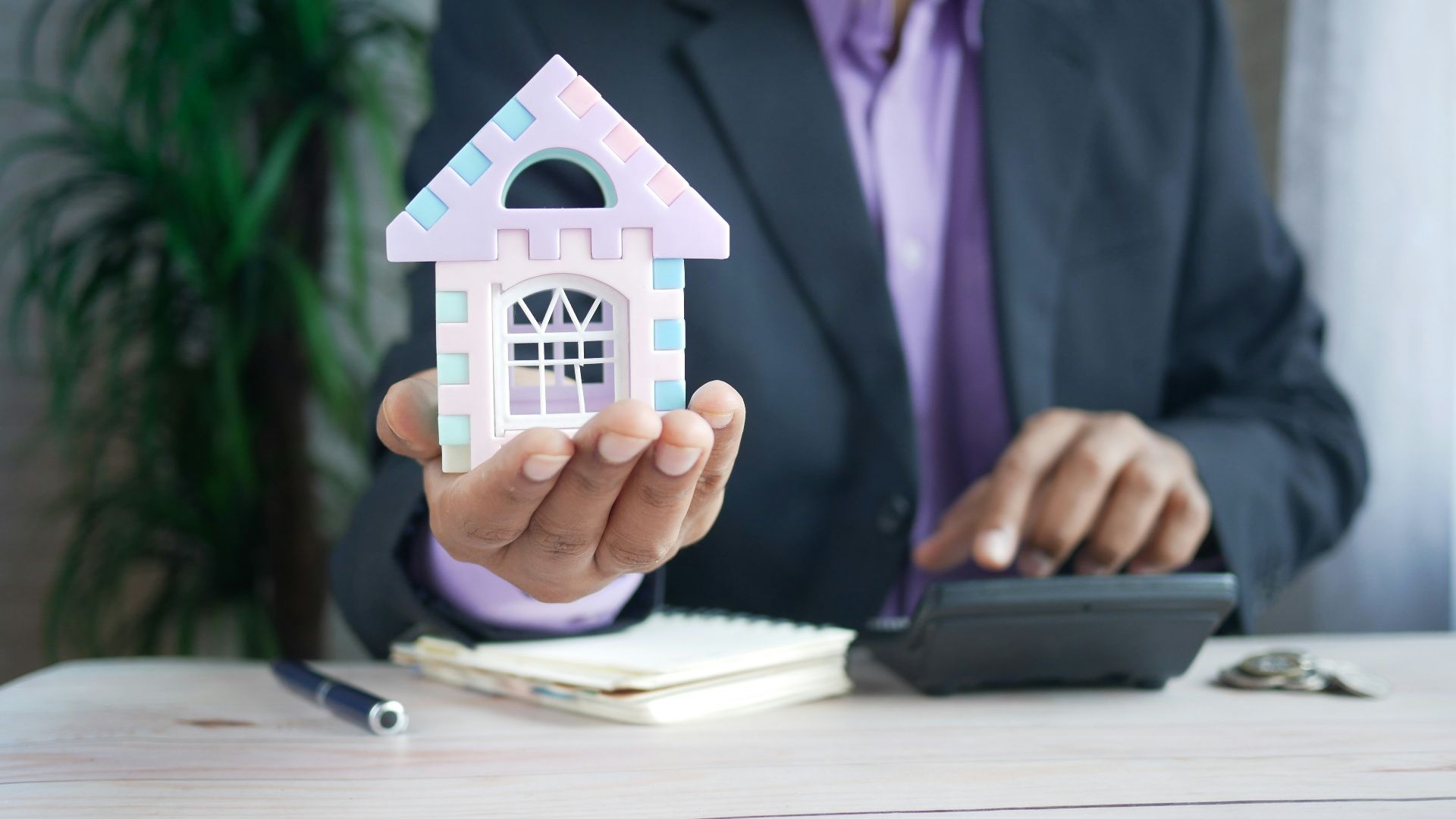 man in purple suit jacket using laptop computer