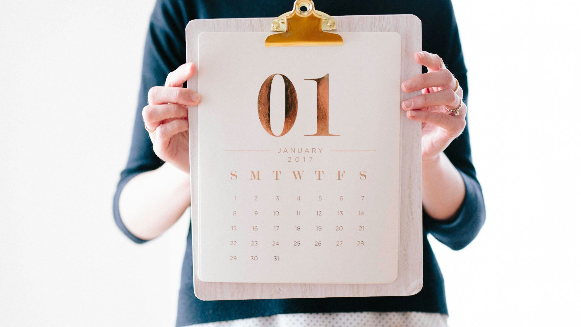person holding calendar at January