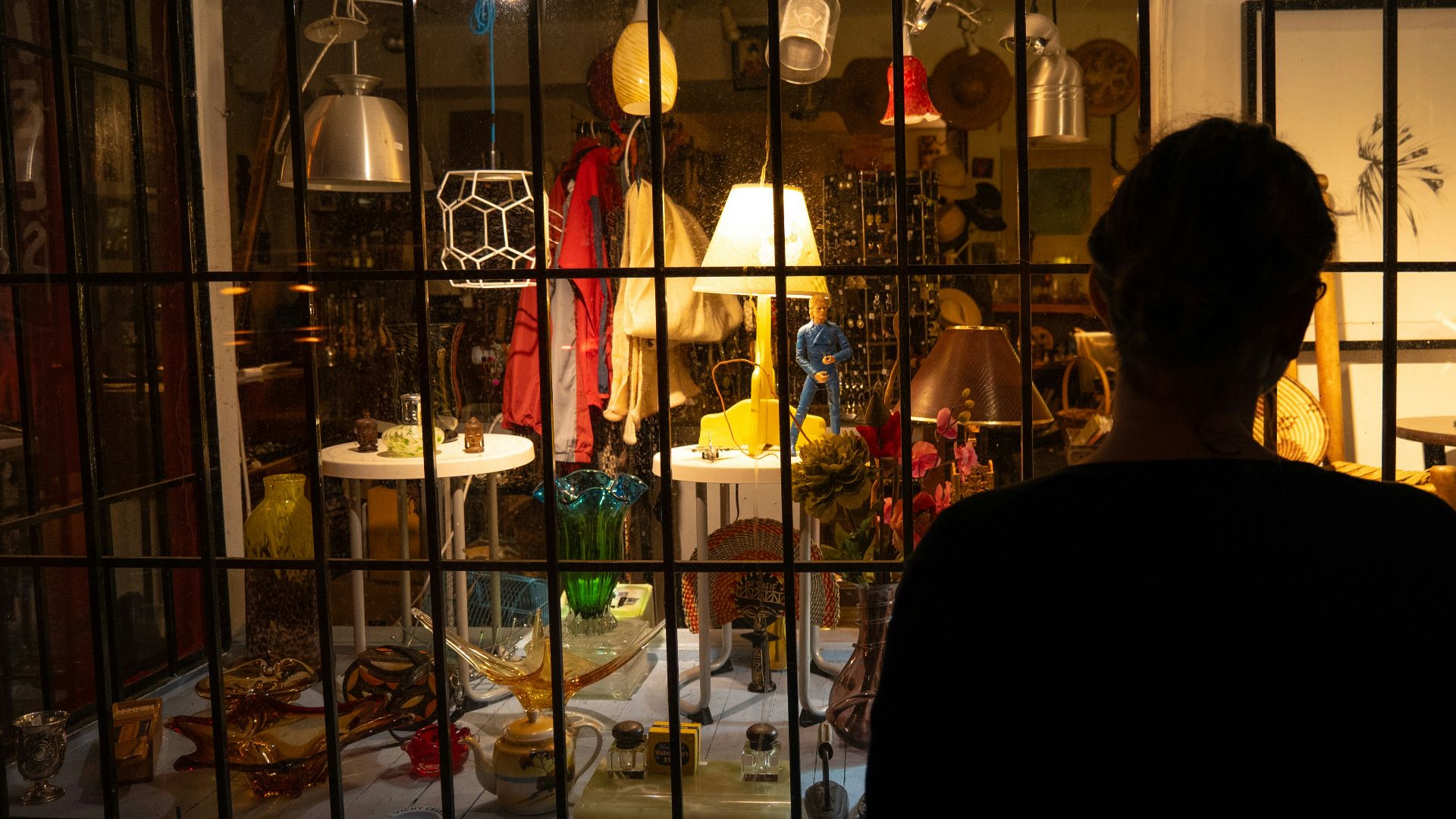 A person standing in front of a store window