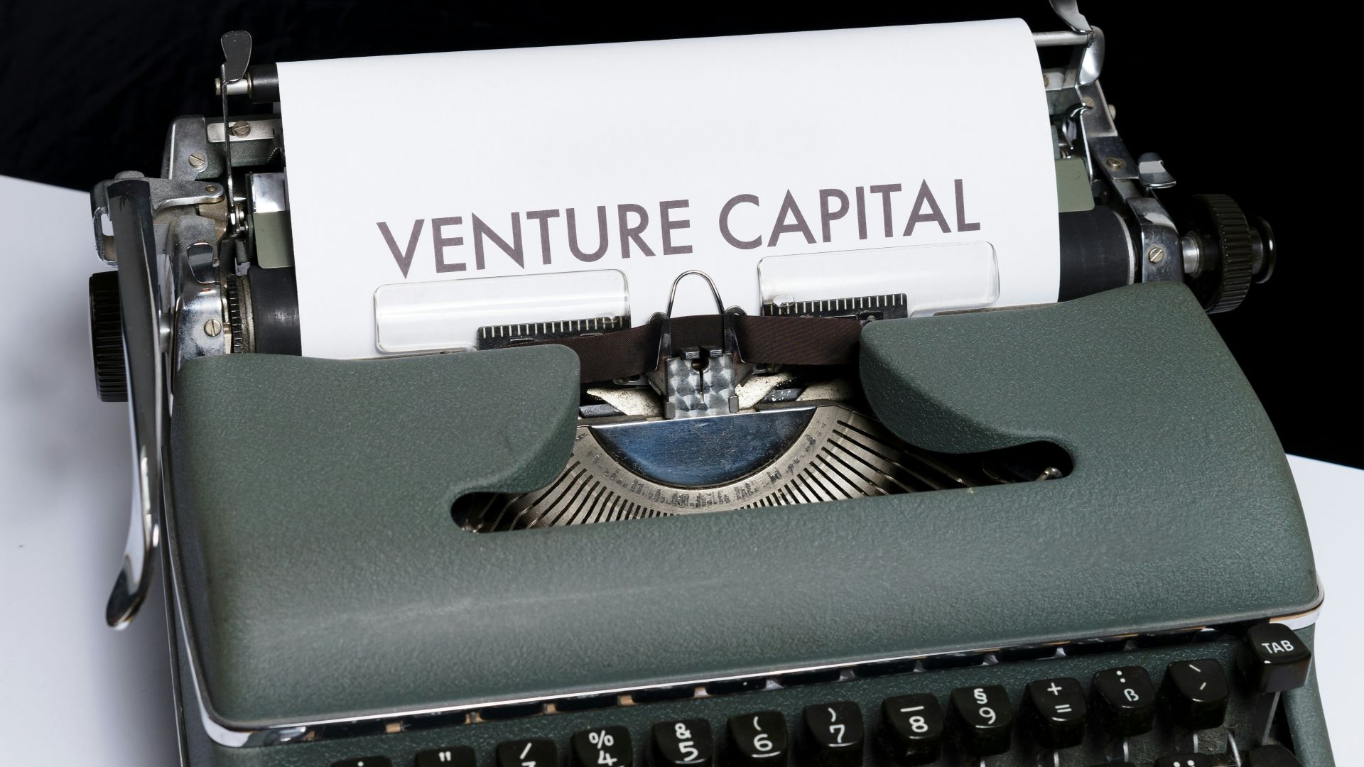 green and white typewriter on black textile