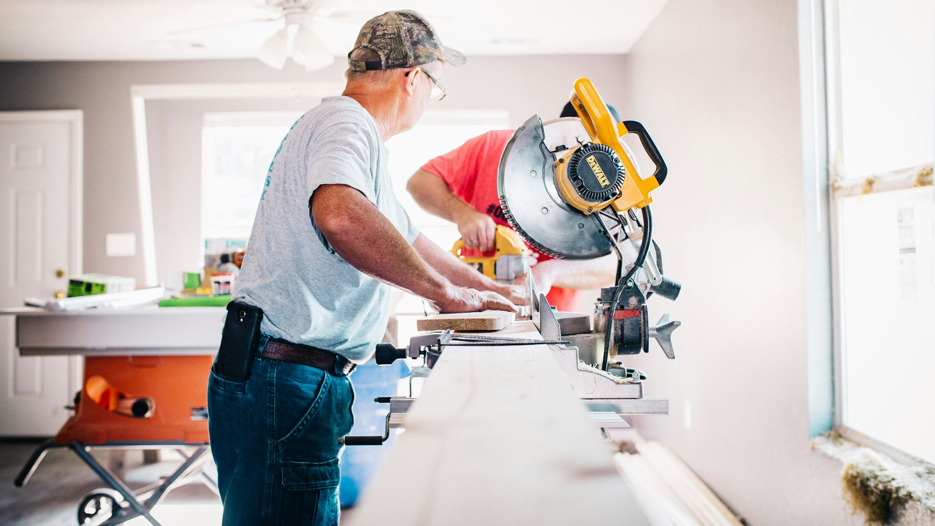 man standing infront of miter saw