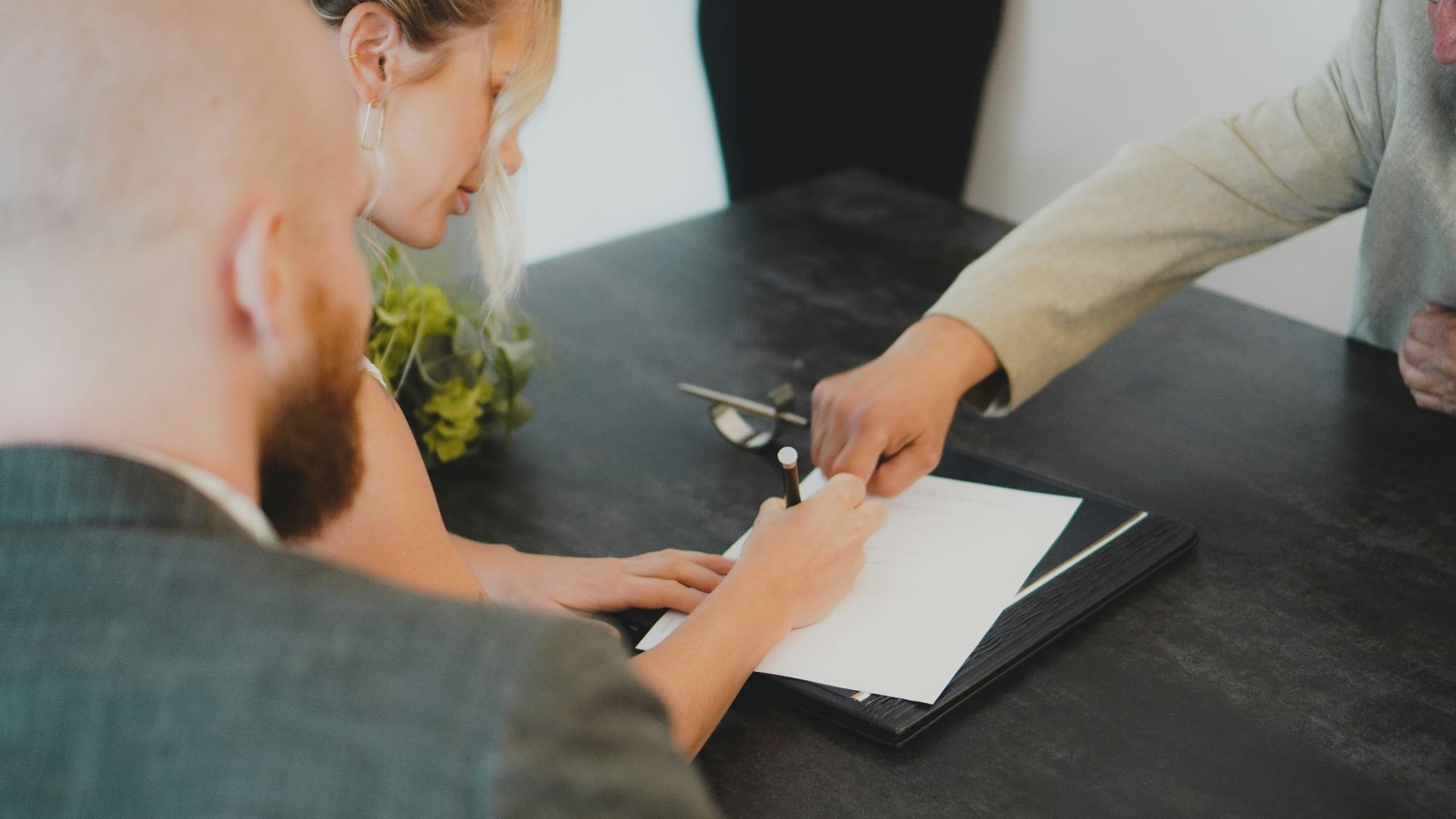 a woman showing a man something on a tablet