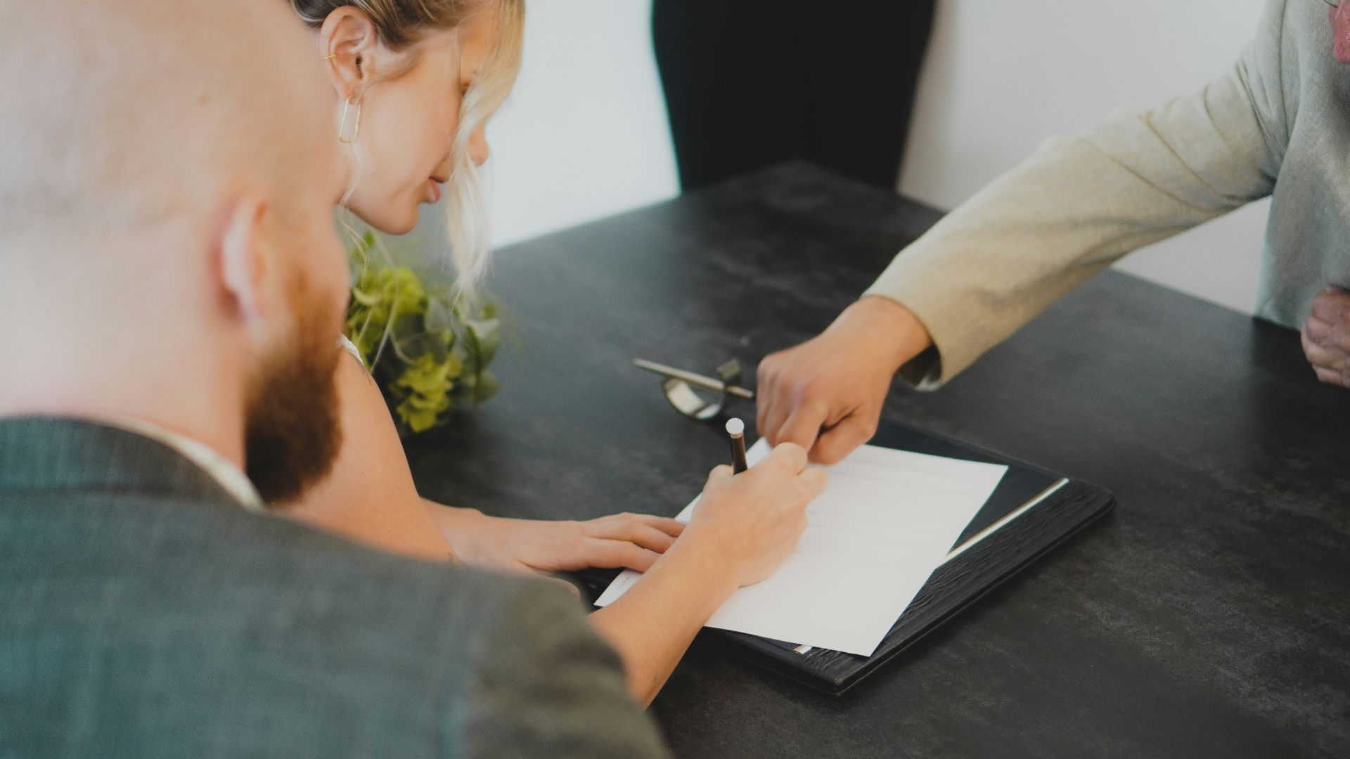 a woman showing a man something on a tablet