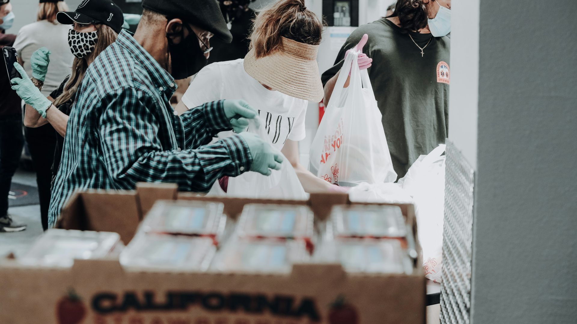 people standing in front of brown cardboard boxes