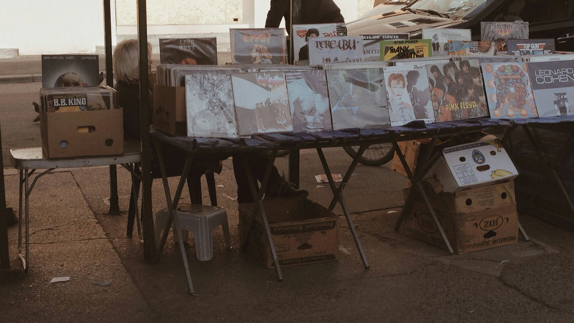 assorted vinyl records lot on display in sidewalk