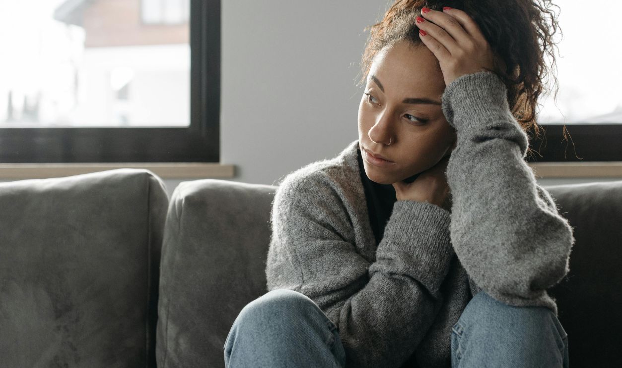Woman in gray sweater and blue denim jeans