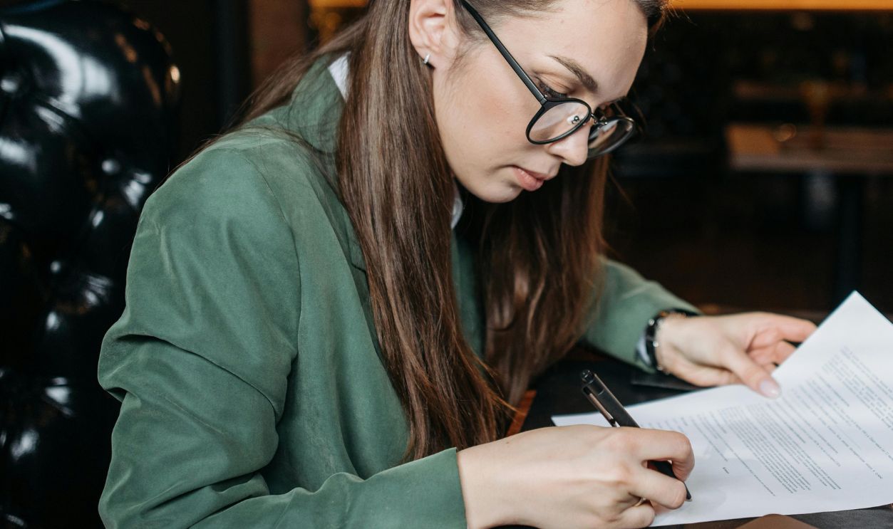 Woman signing a document