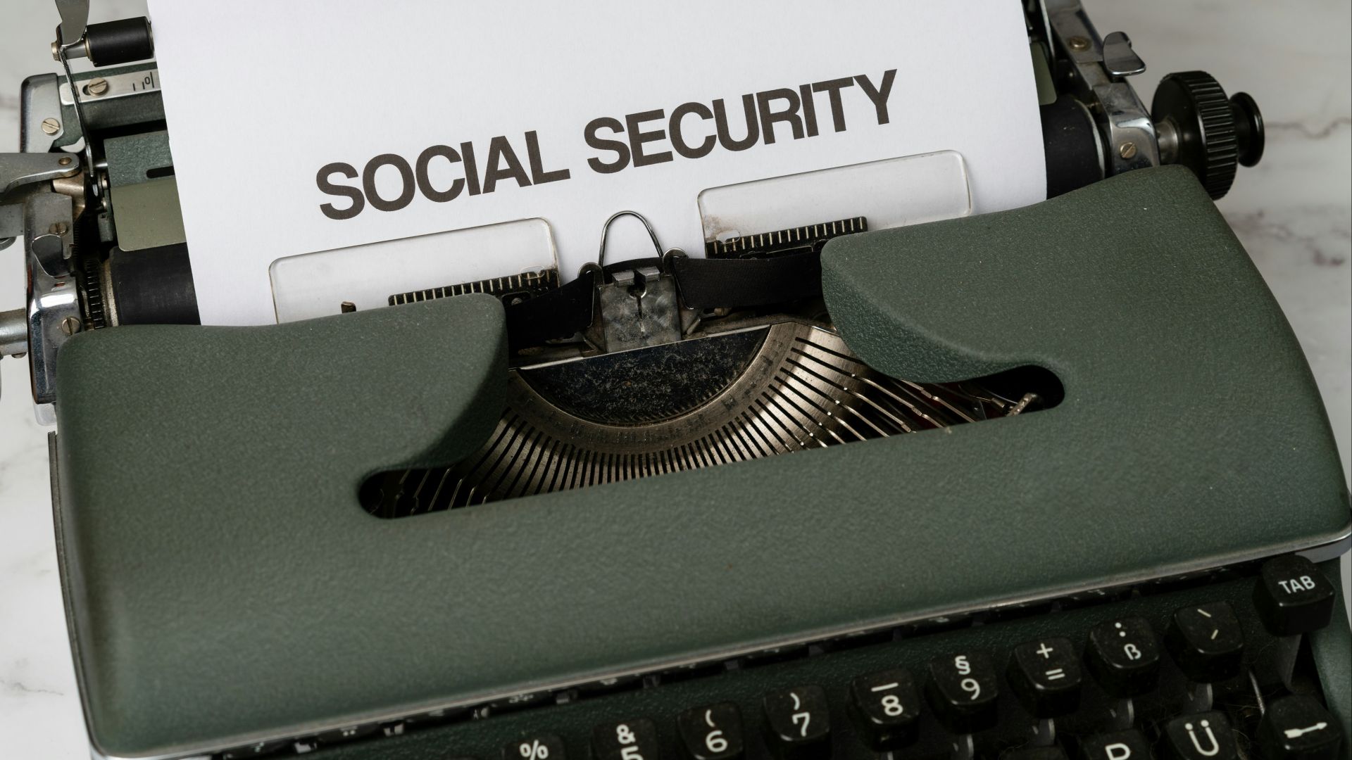 a close up of a typewriter with a paper that says social security