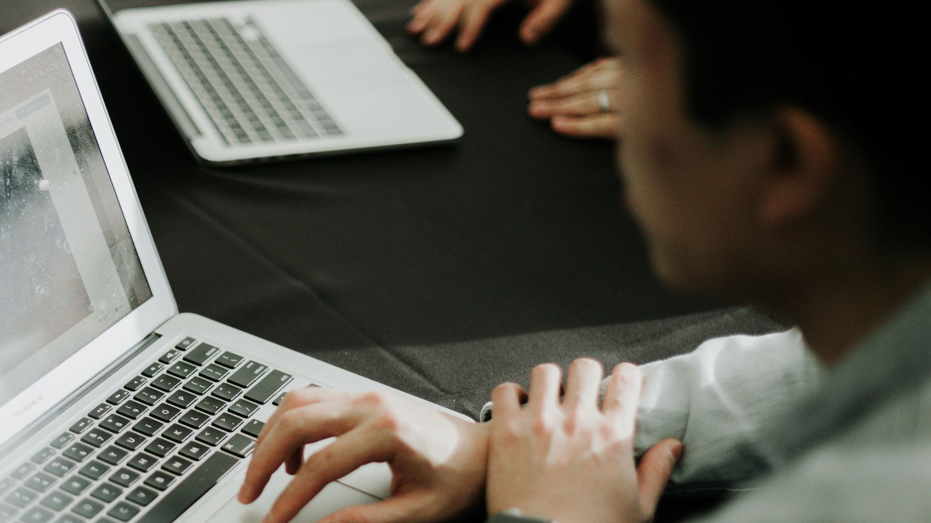 a man sitting in front of a laptop computer