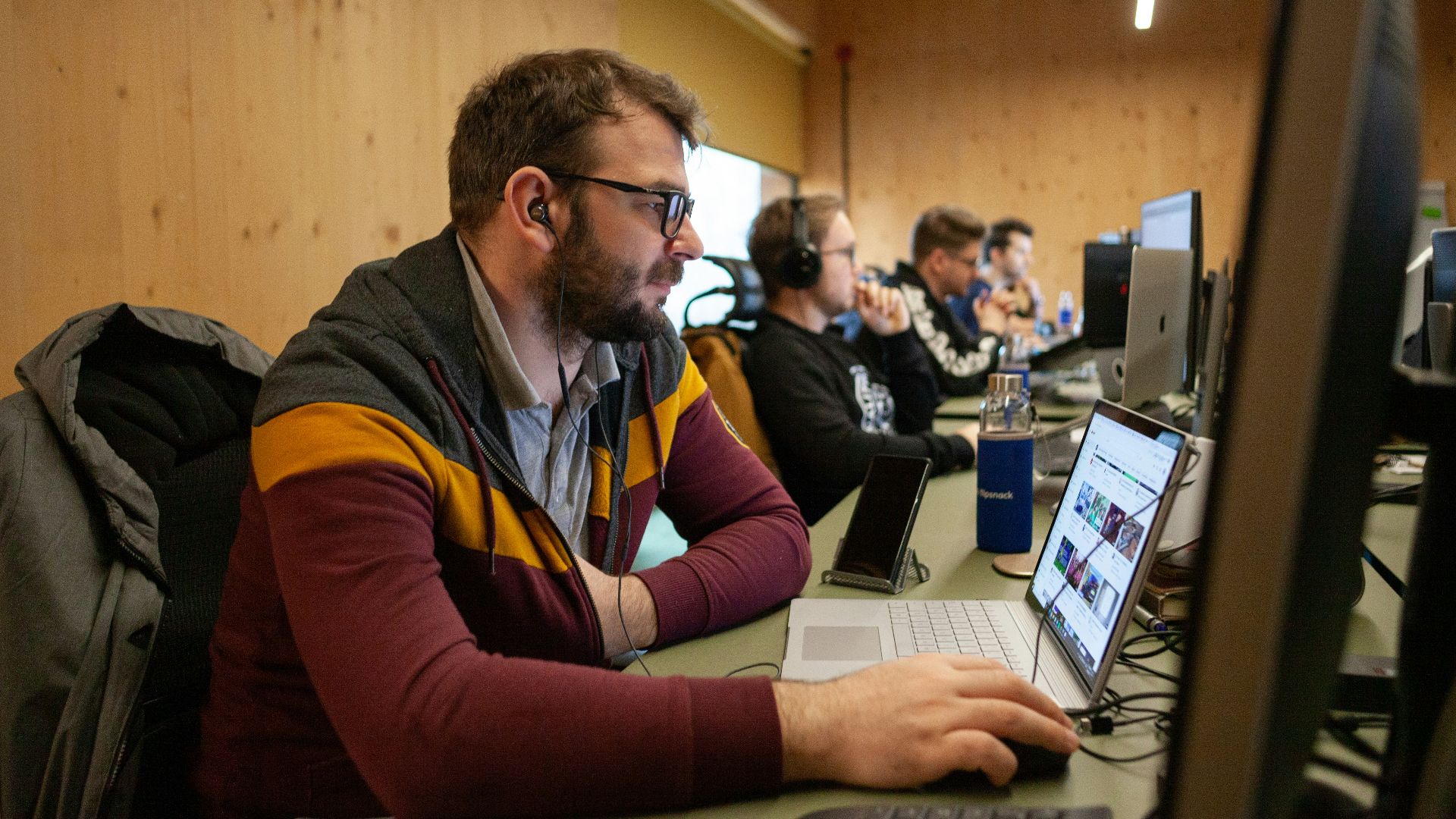 a man sitting in front of a laptop computer
