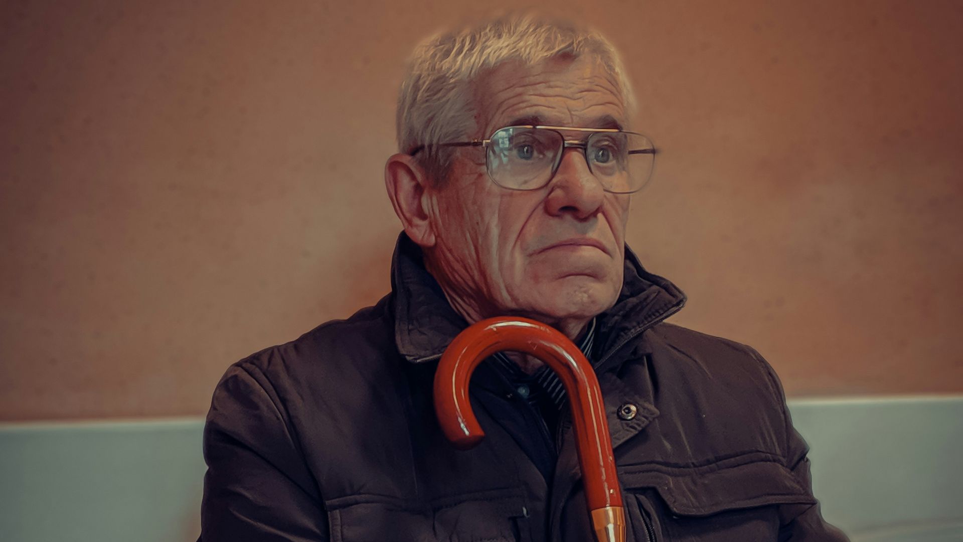 man in black jacket wearing eyeglasses
