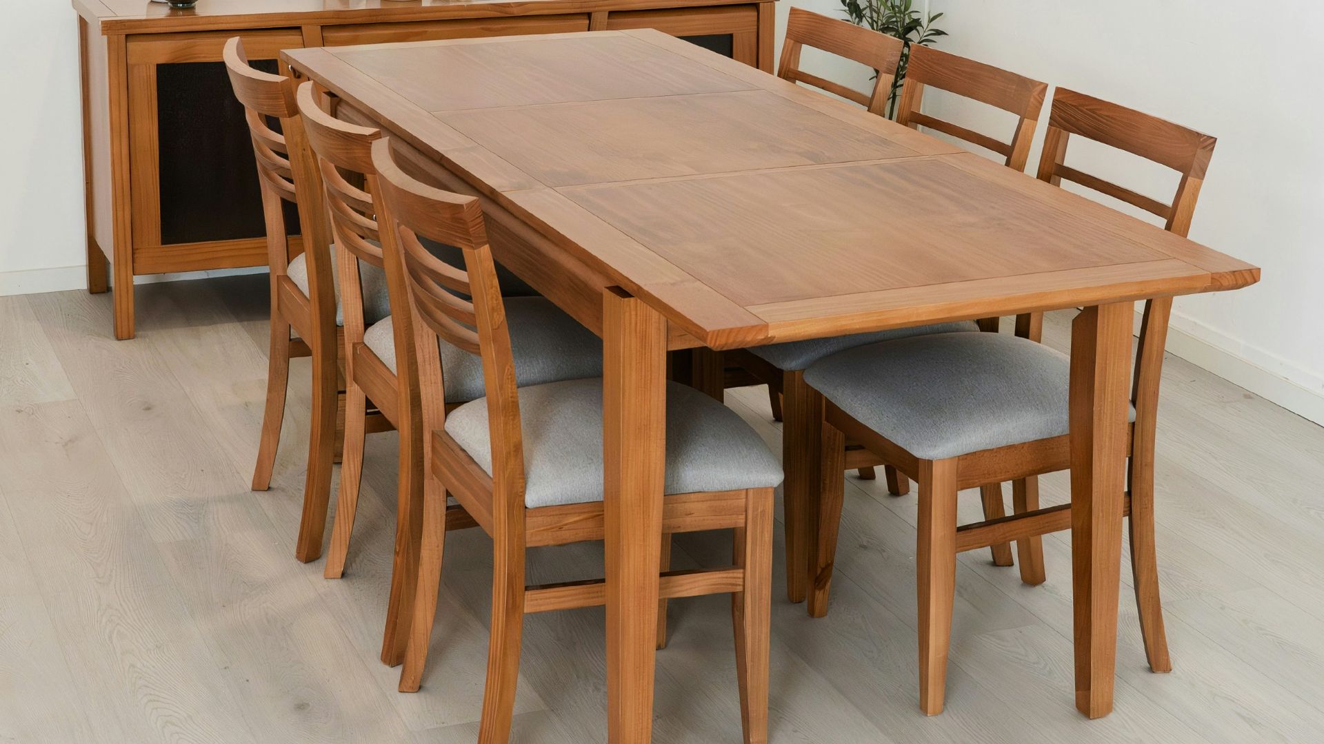 Wooden dining table with chairs and sideboard