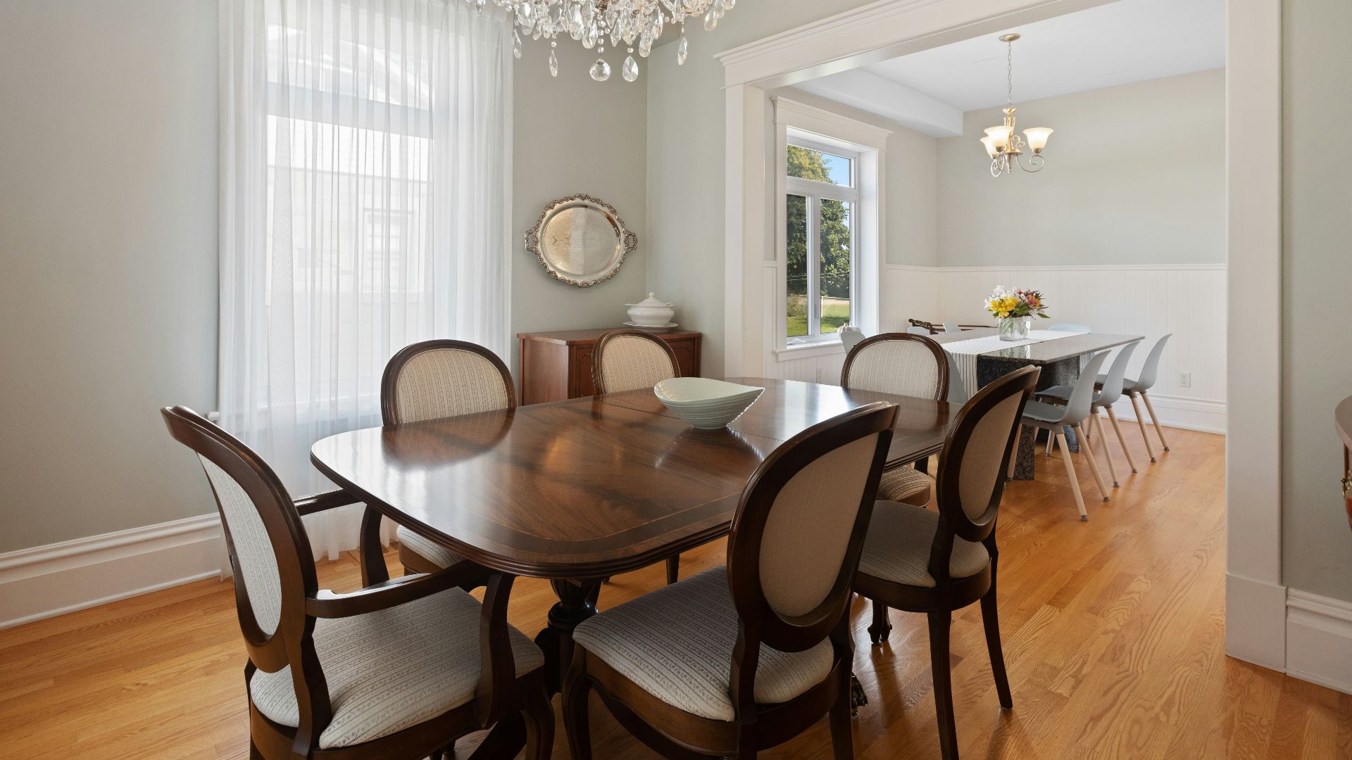 a dining room table with chairs and a chandelier