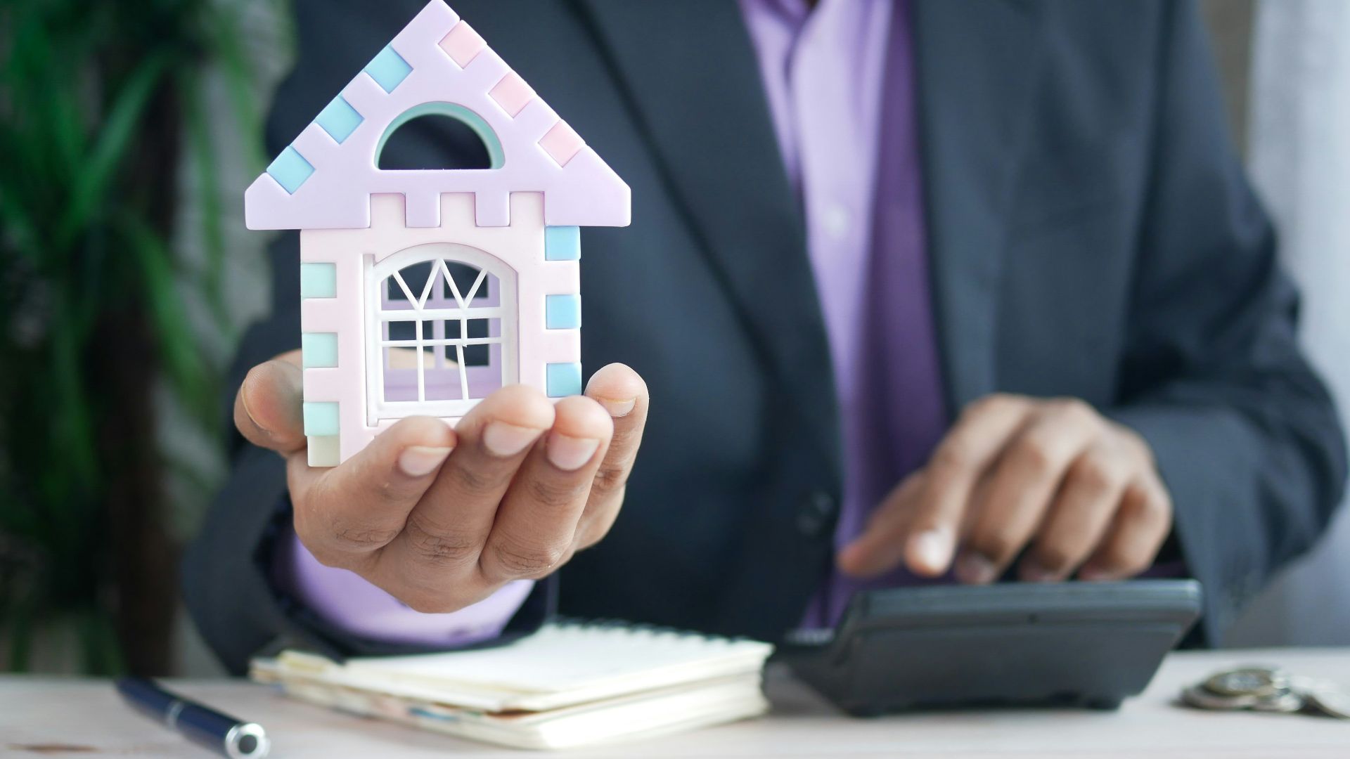 man in purple suit jacket using laptop computer
