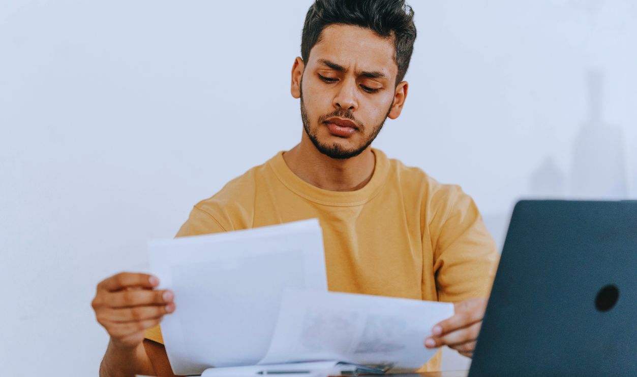 Man looking through documents at workplace