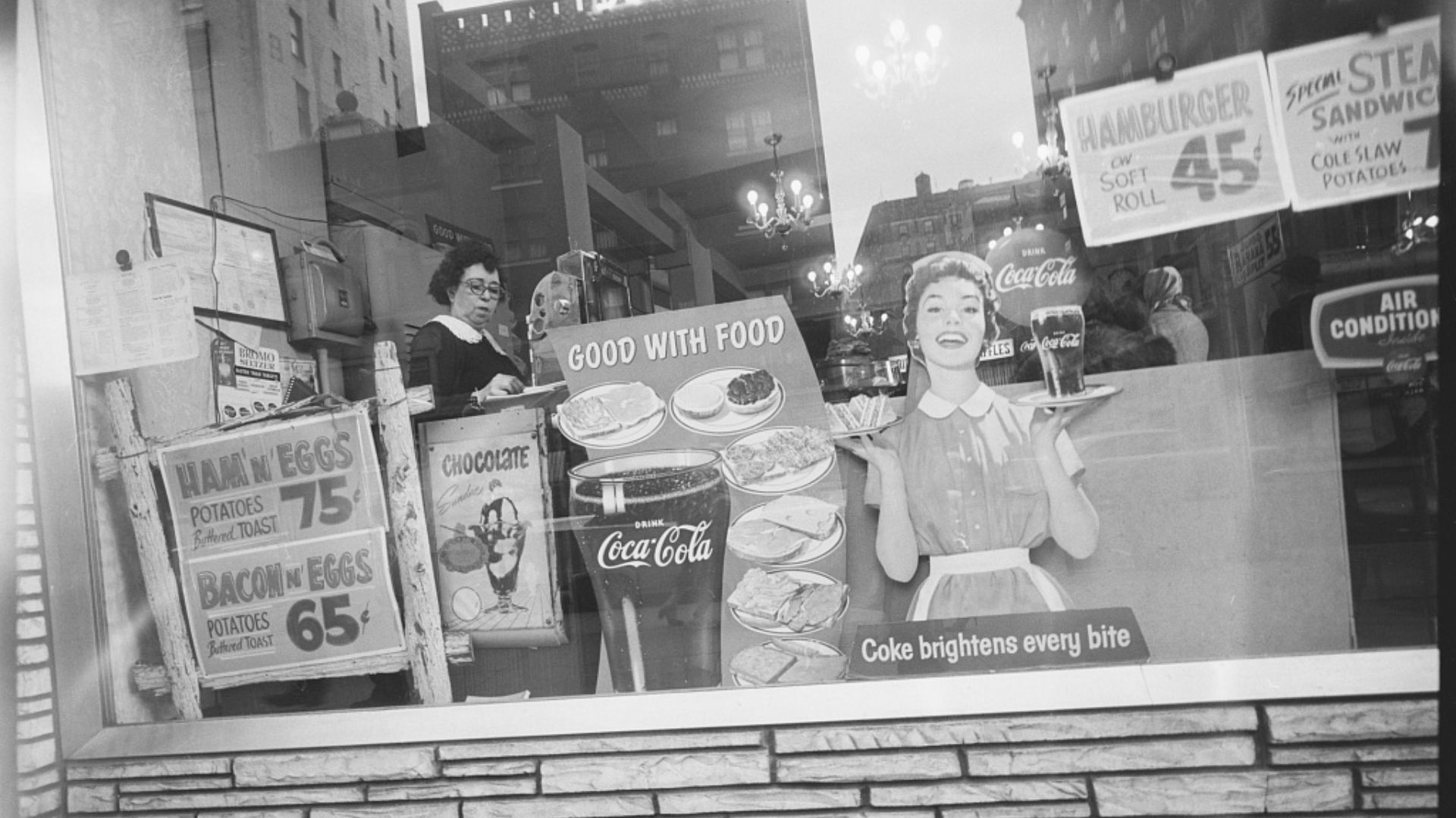 File:(Woman at cash register viewed through diner show window with buildings reflected) (LOC).jpg