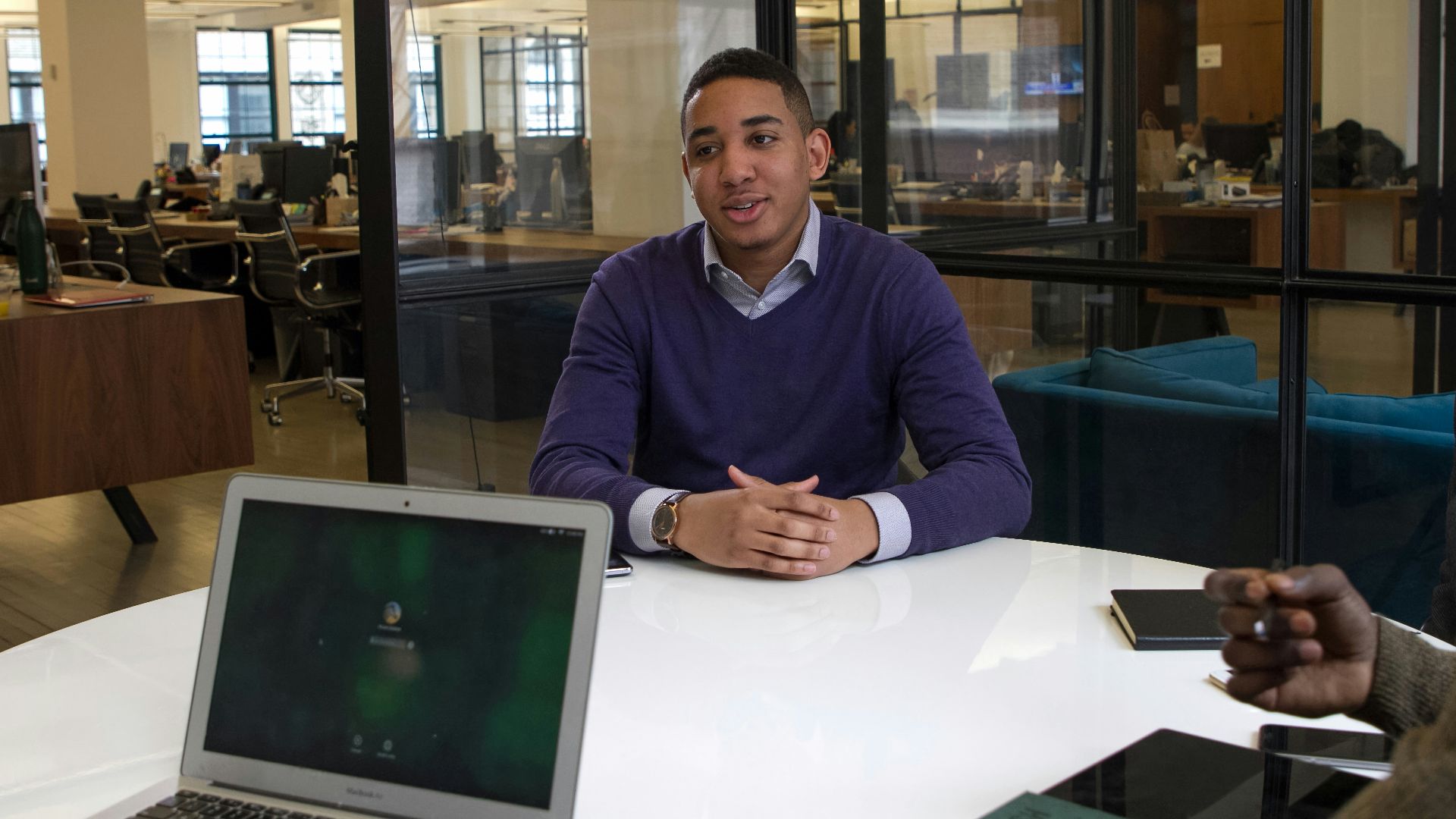 a man sitting at a table with a laptop