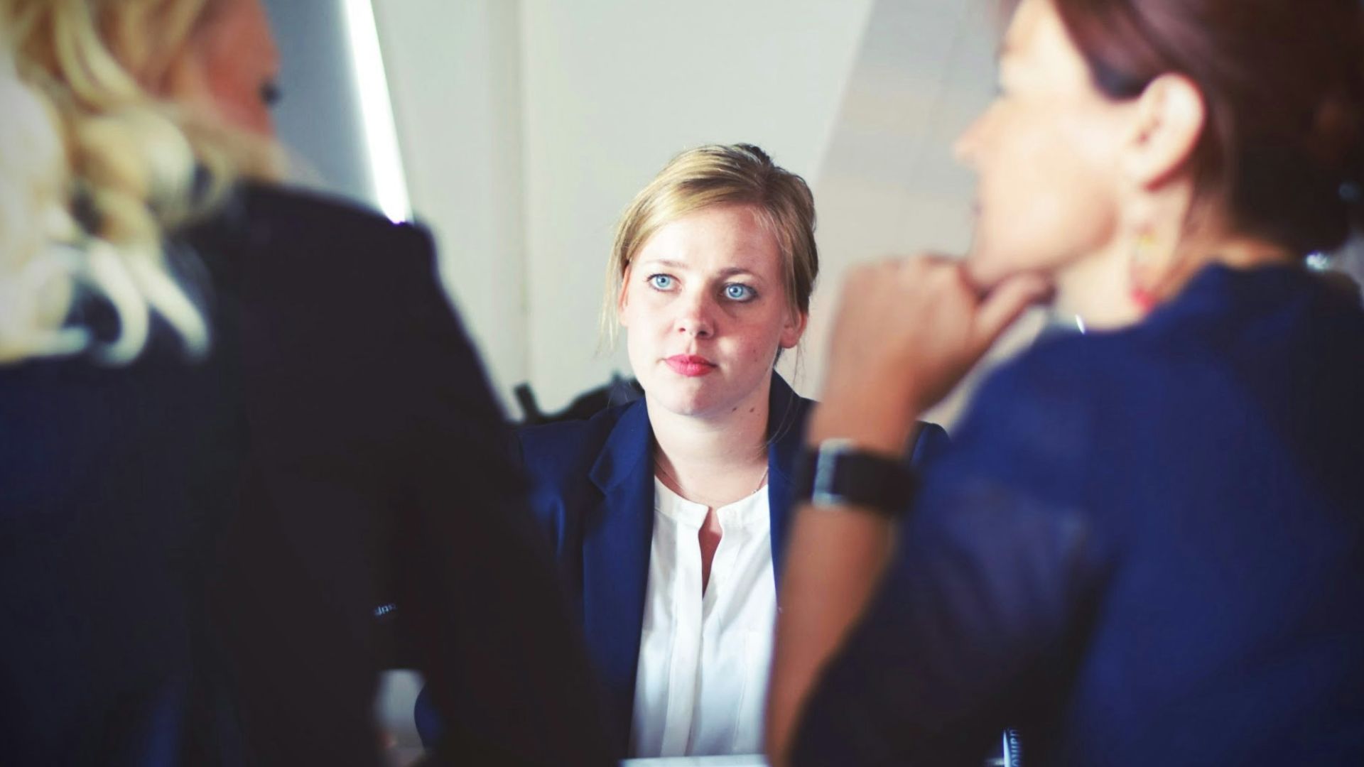three women sitting beside table