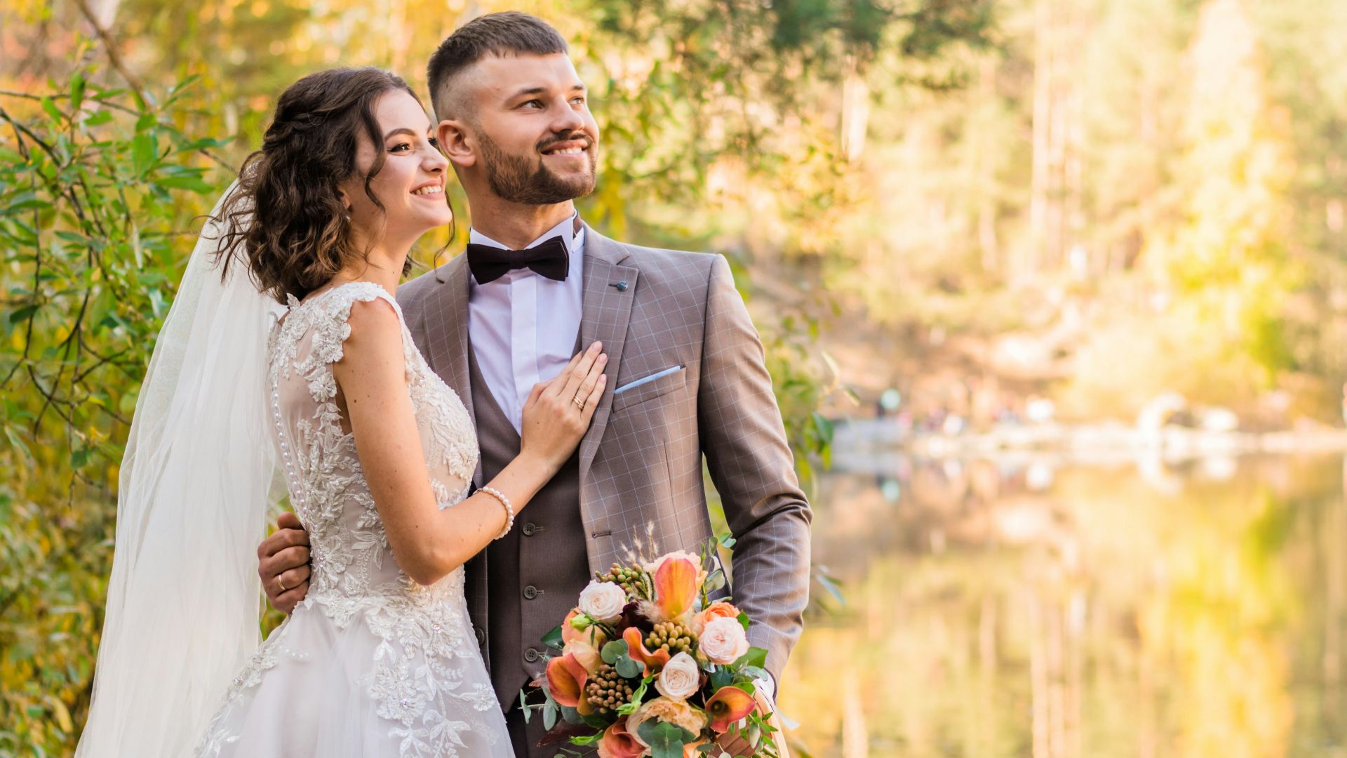 man in gray suit and woman in white wedding dress