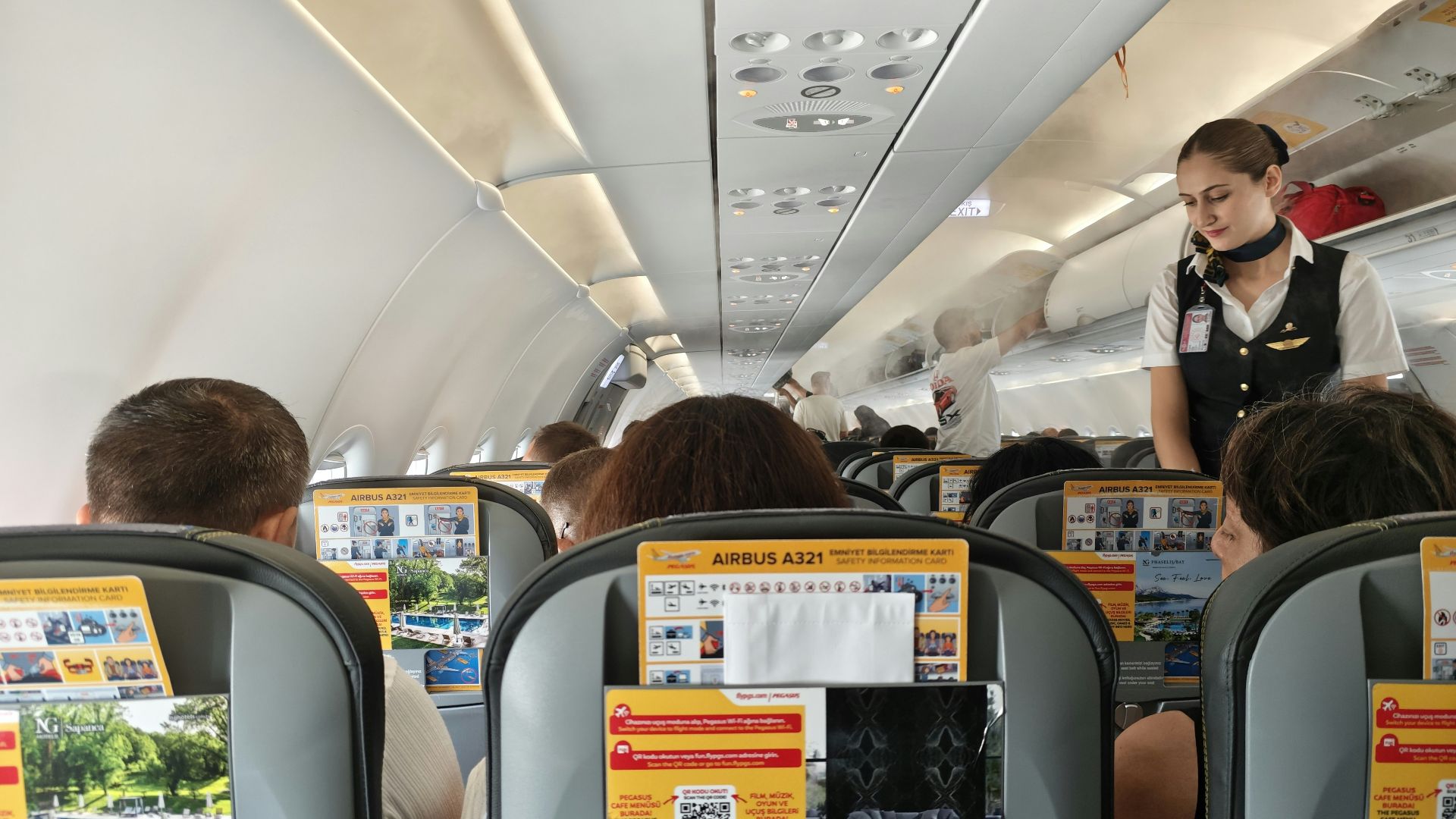 Flight attendant serving passengers on an airplane