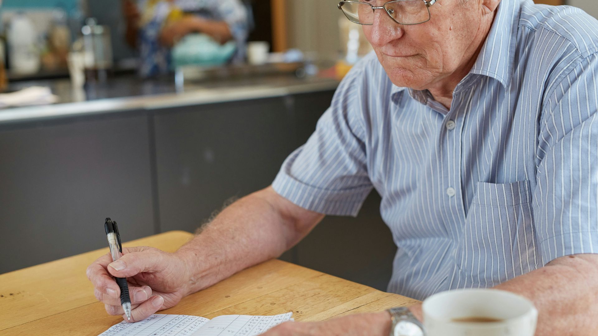 a person writing down blood glucose results