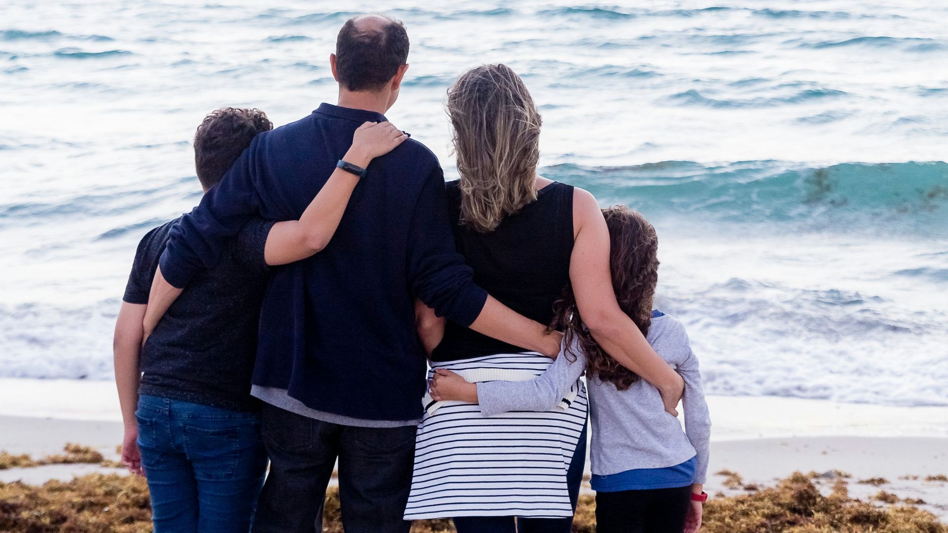 a family of four on a beach